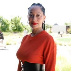 Tracee Ellis Ross wearing red lipstick and braids
