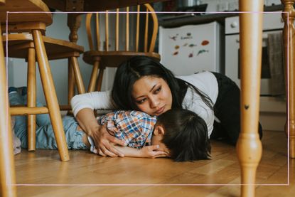 Stock image of a parent on floor comforting a child having a tantrum, please note this isn't the Norland Nanny mentioned in the article