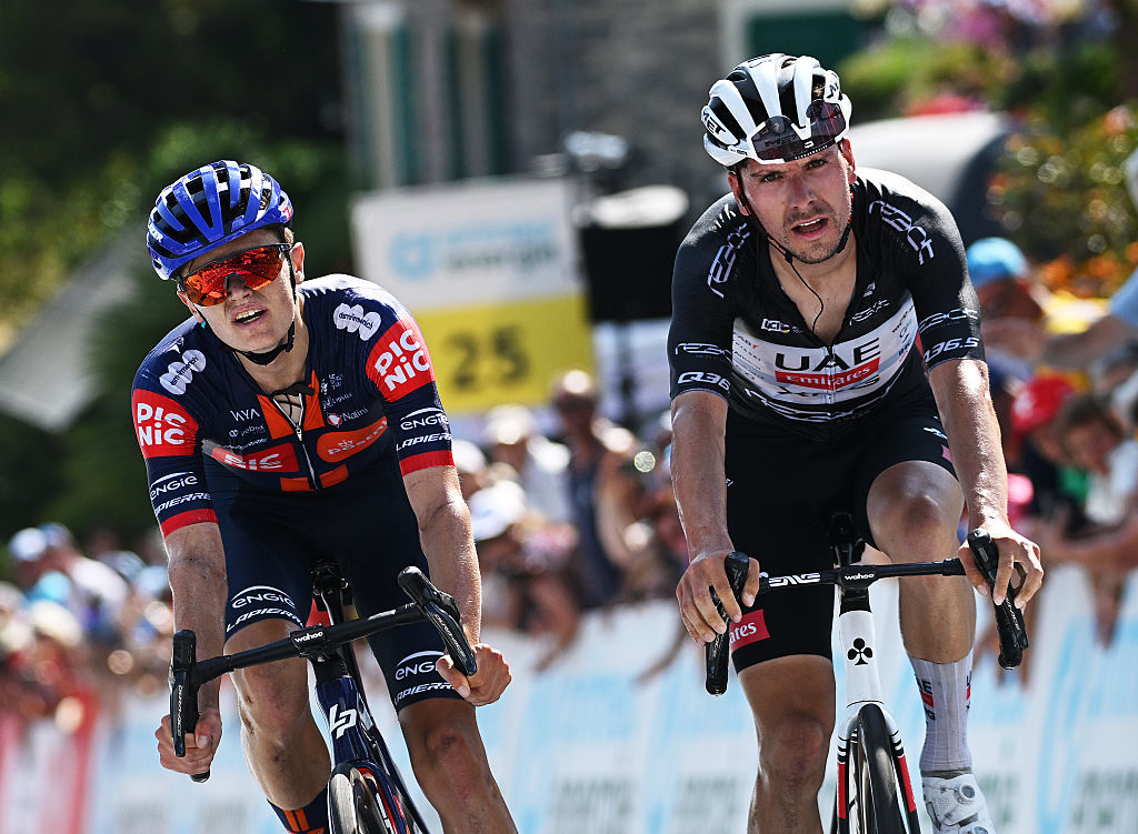 SANTA MARIA IN CALANCA, SWITZERLAND - JUNE 19: (L-R) Oscar Onley of Great Britain and Team Picnic PostNL reacts as stage winner ahead of Joao Almeida of Portugal and UAE Team Emirates - XRG - Black Points Jersey during the 88th Tour de Suisse, Stage 5 a 183.8km stage from La Punt to Santa Maria in Calanca 941m / #UCIWT / on June 19, 2025 in Santa Maria in Calanca, Switzerland. (Photo by Tim de Waele/Getty Images)