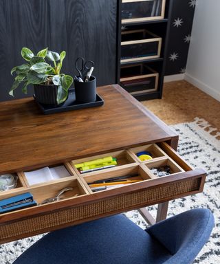 Small office desk with neatly divided drawers