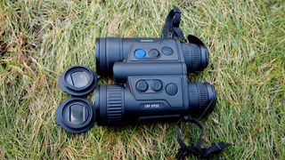 Pulsar Merger LRF XP35 binoculars on a grassy surface