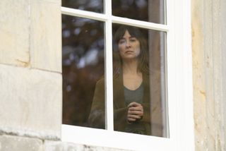 Morven Christie as Lexie Noble staring out of a window in Payback