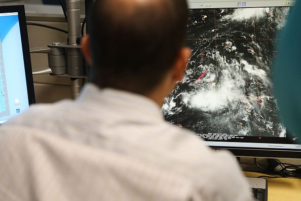 A man looks at a storm forming in the Atlantic.