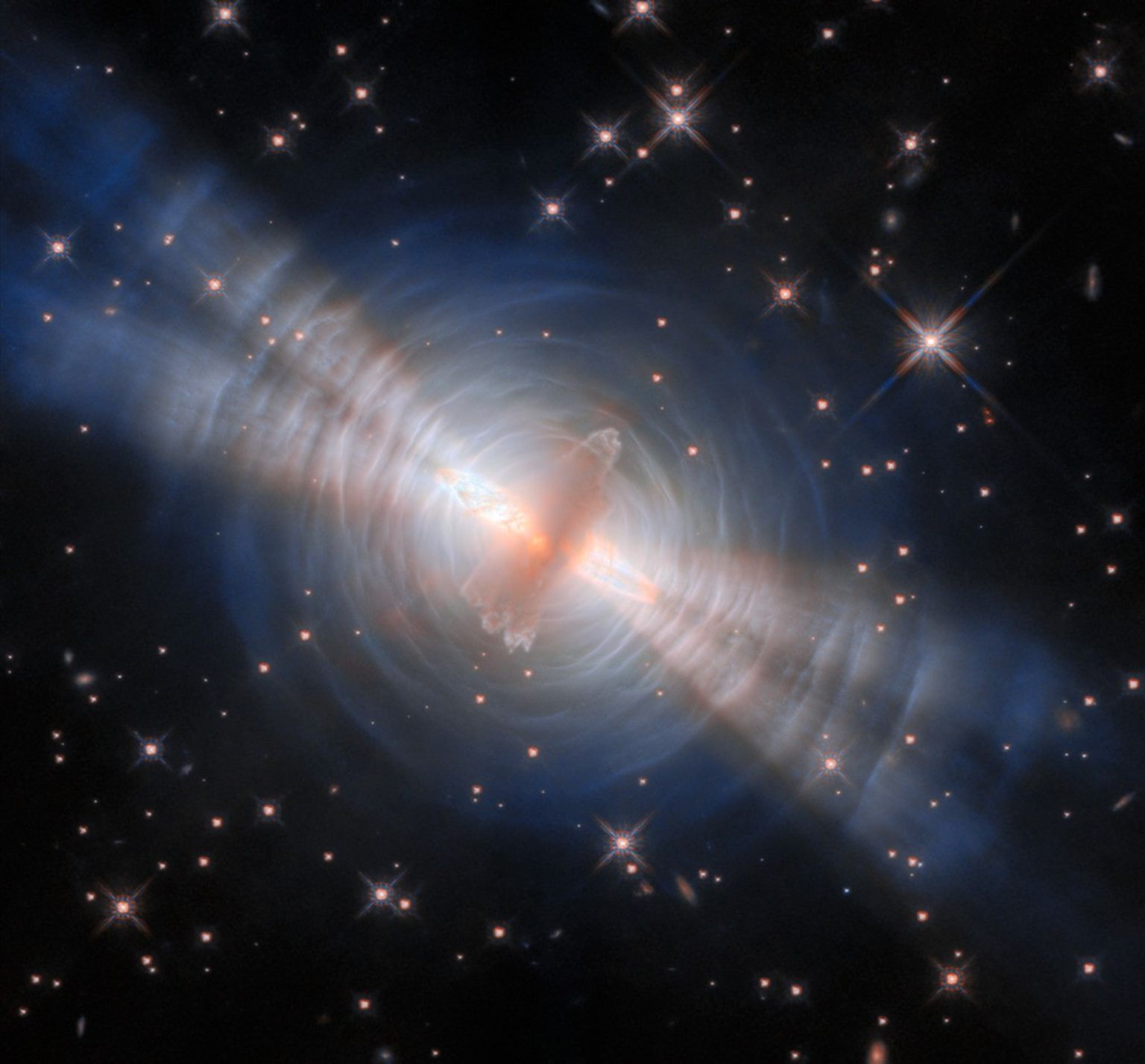 A photograph of the Egg Nebula, a pre-planetary nebula, captured by he Hubble Space Telescope