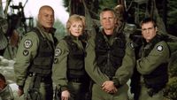 Screenshot from Stargate SG-1 showing the four main cast members in military attire.
