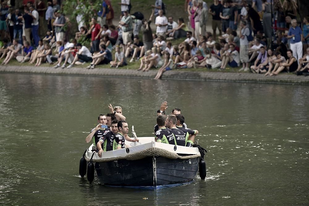 France's Bretagne-Seche Environnement cycling team arrive on a canal boat to attend the team presentation