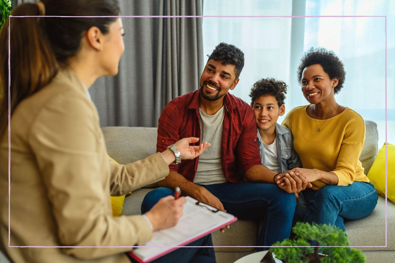 A family of three speaking to a woman with a clipboard