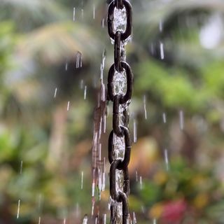 Rainfall coming down links of a rain chain