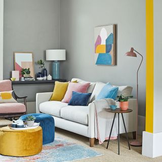 Grey living room with cream sofa and yellow and blue accents