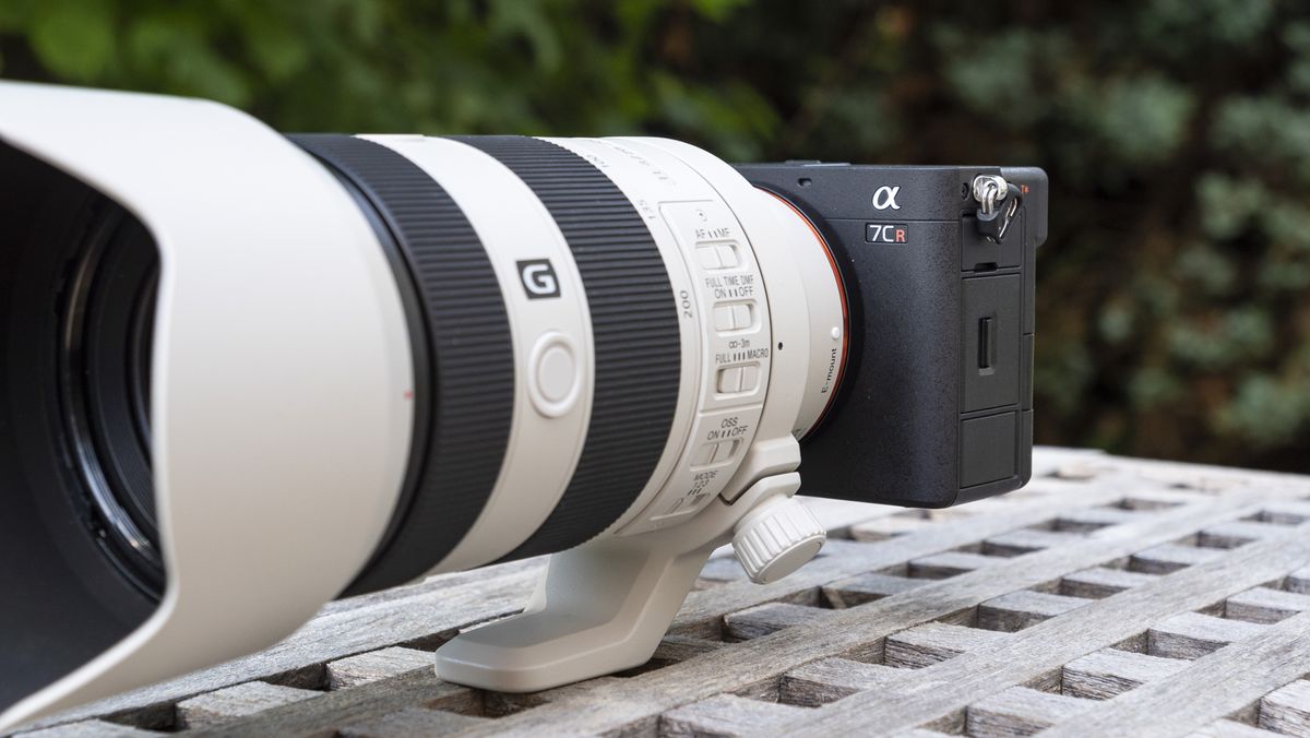 Sony A7C R mirrorless camera outside on a wooden table with FE 70-200mm F4 II lens attached
