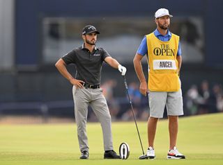 Ancer looks on with his caddie