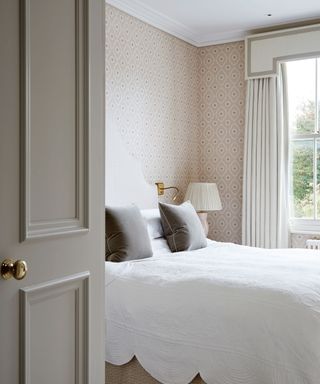 Neutral bedroom with patterned wallpaper elegant period house in London