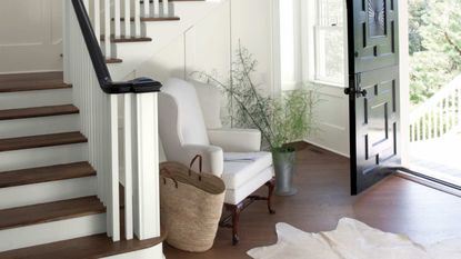 A large open entryway with lots of natural light and staircase