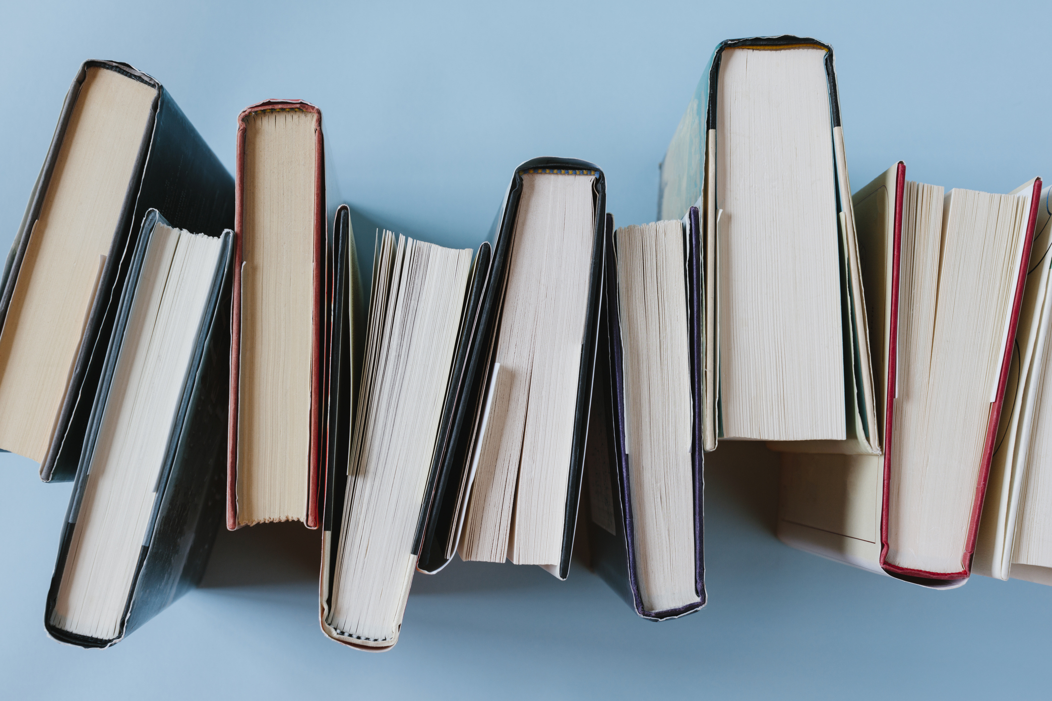 top view of numerous books on a blue background