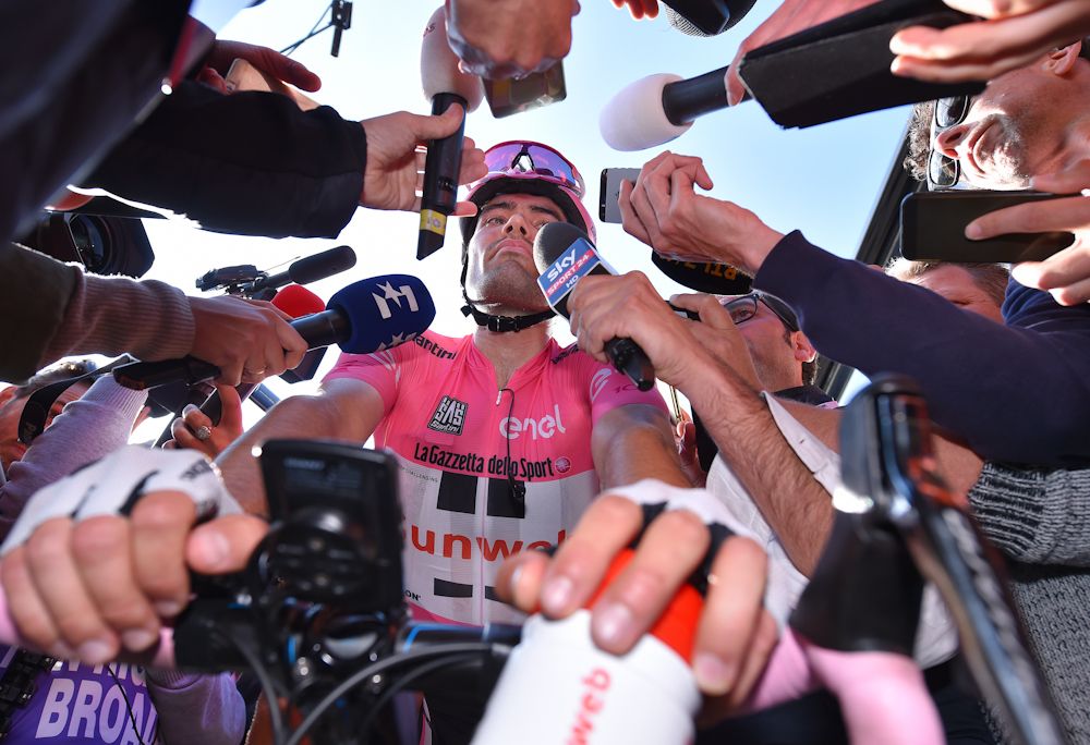 Tom Dumoulin is surrounded by reporters after losing the pink jersey during stage 19