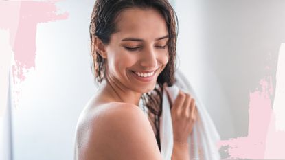 A woman smiling as she towel dried her wet hair after learning how often should you wash your hair 