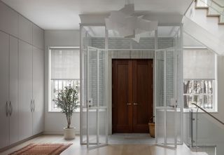 minimalist entryway with modern glass vestibule