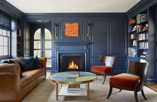 dark blue living room with tan sofa