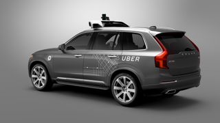 A grey Volvo XC90 with Uber branded self driving tech