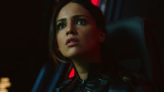 Eiza Gonzalez looks up with great concern in Godzilla vs. Kong.