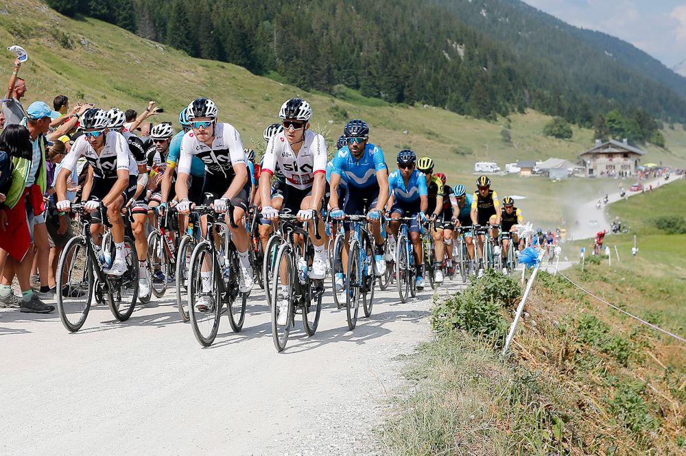 Team Sky leads the peloton up the gravel climb