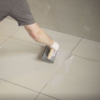 grouting floor tiles with tiling tool