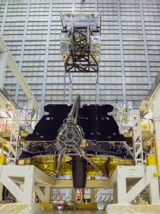 A view of the crane lifting the science instrument package onto NASA's James Webb Space Telescope.