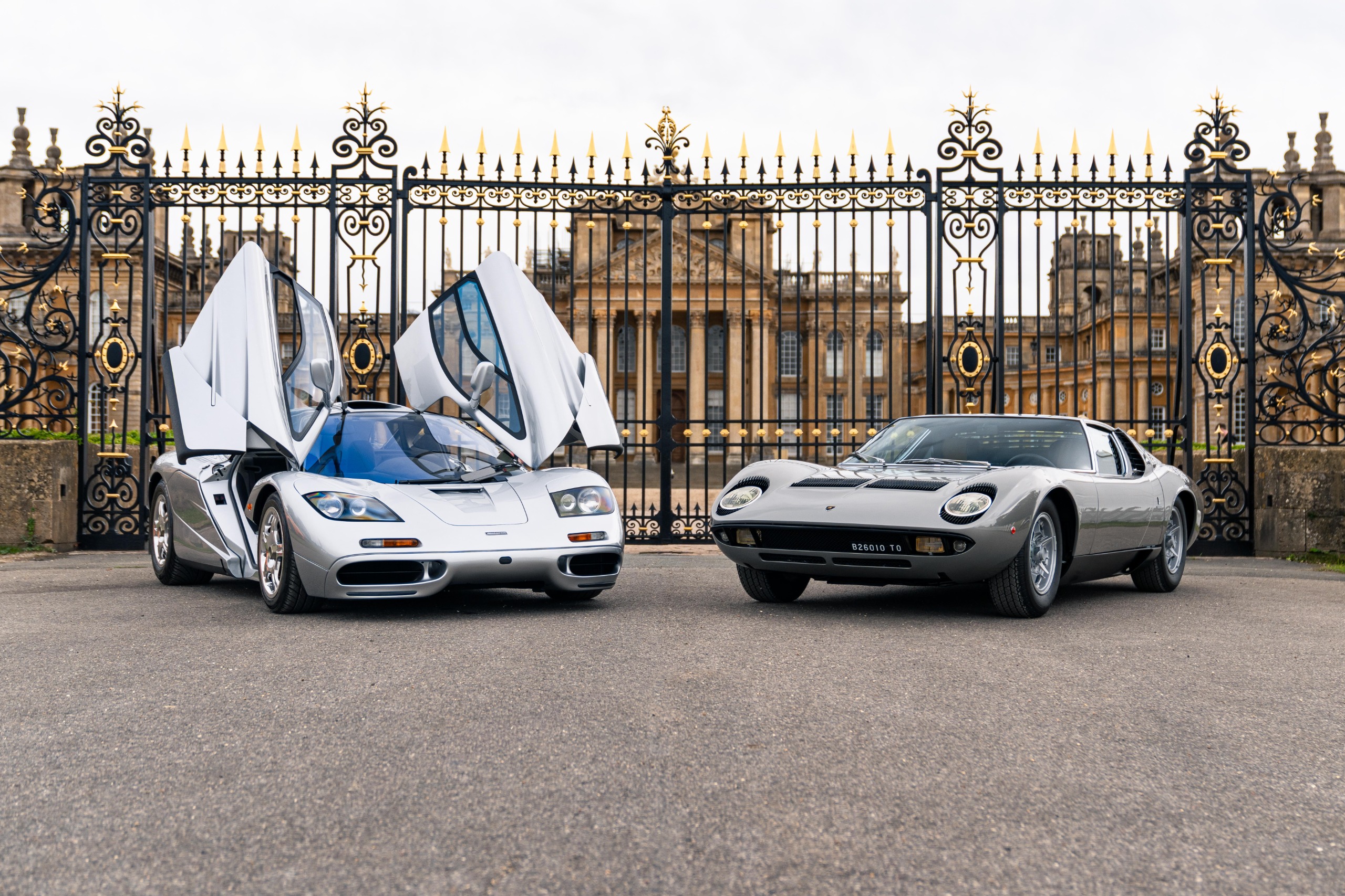 On the left, a Mclaren F1 with its doors up, on the right a Lamborghini Miura