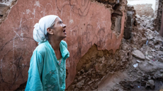 A woman cries out among the rubble of destroyed buildings in Marrakech