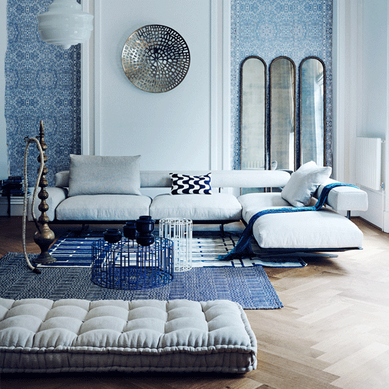 living room with sofaset with cushions and rug on floor
