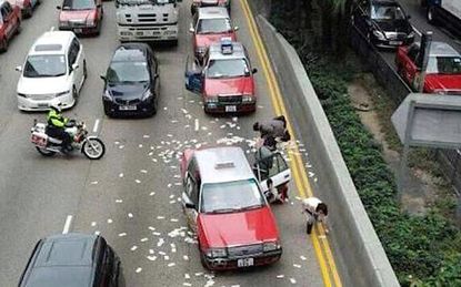 Cash spill litters Hong Kong freeway, with predictable results