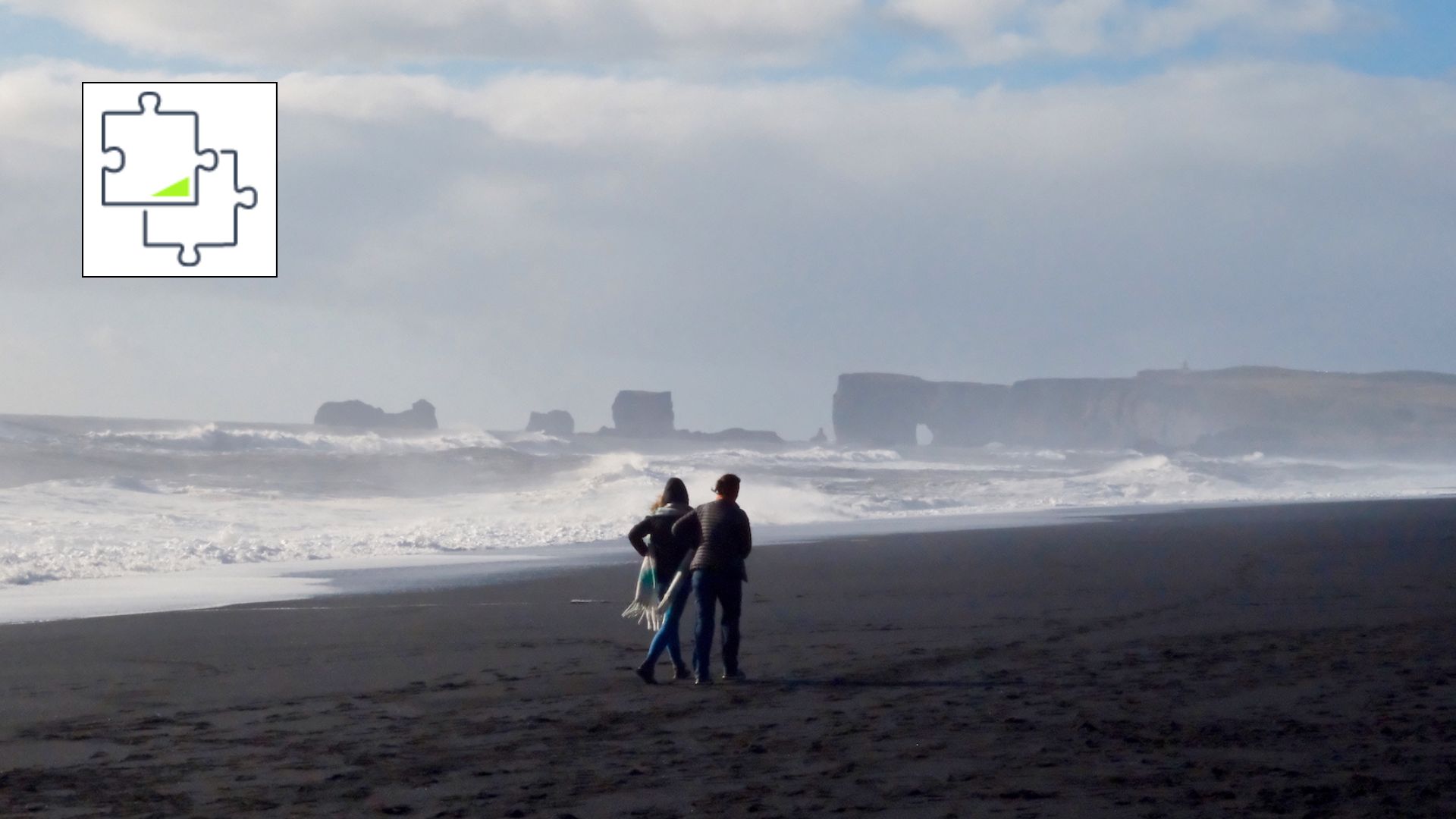 A photo of a couple on a windswept beach in Iceland