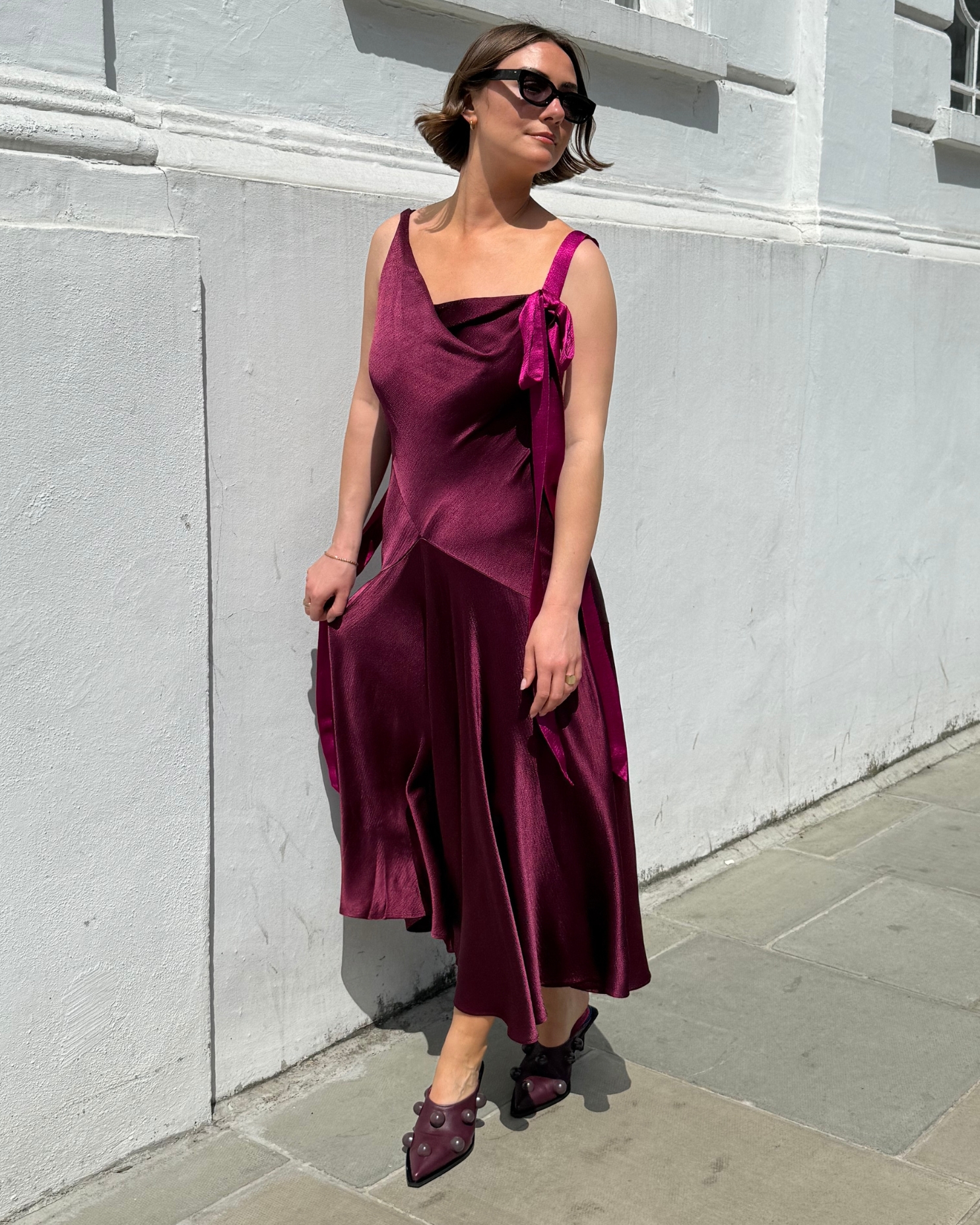 Sophie Robyn Watson wearing a burgundy silk dress and purple heeled shoes from the ROKSANDA x & Other Stories collection.