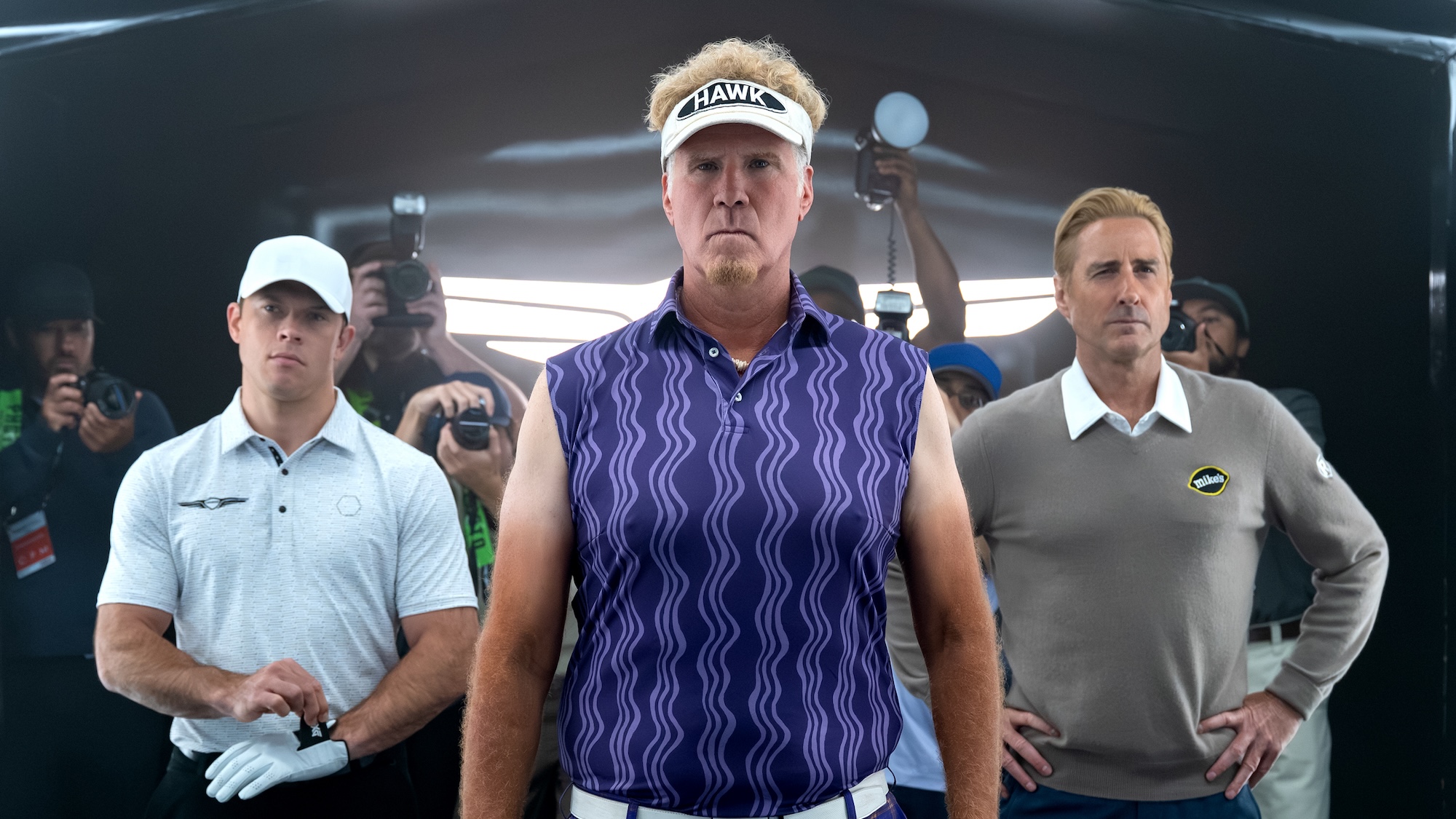 Lonnie in purple suit and visor standing with Lance and Golden in Episode 105 of The Hawk