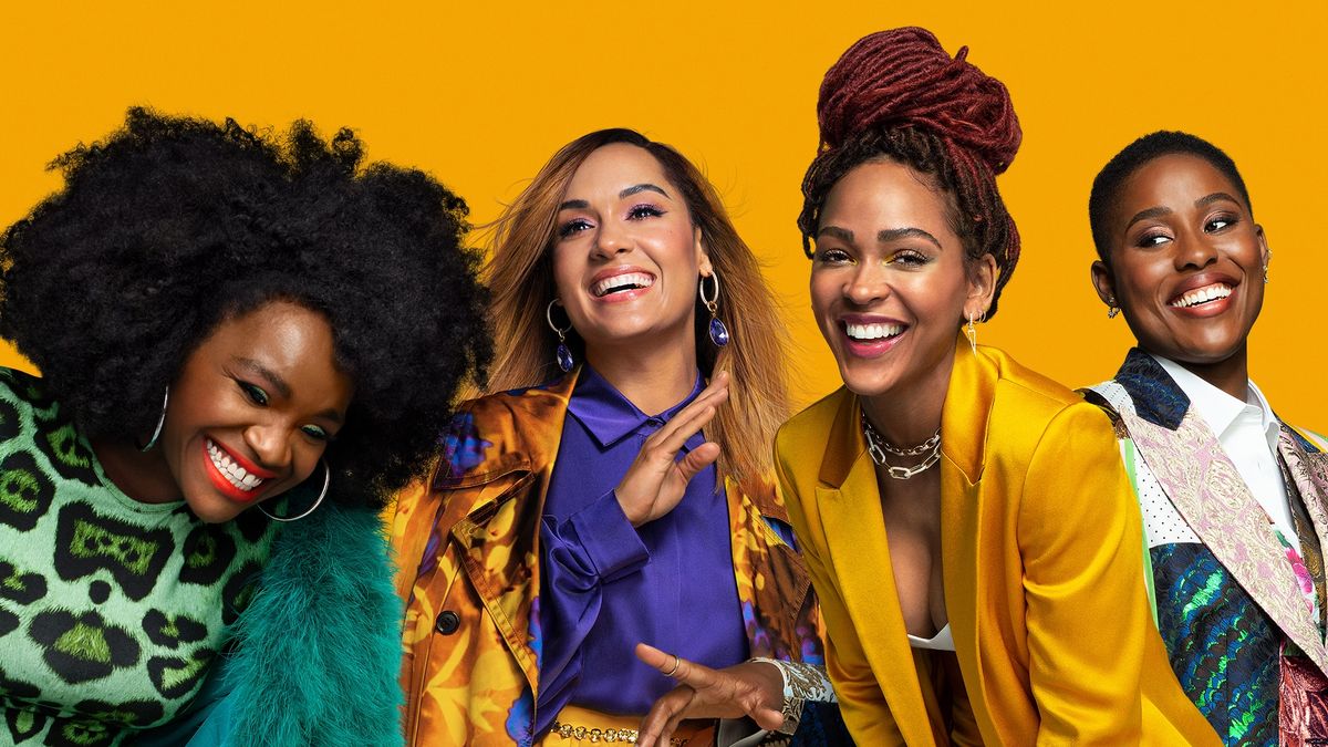 Angie, Quinn, Tye and Camille laughing at each other against a yellow background in Harlem.