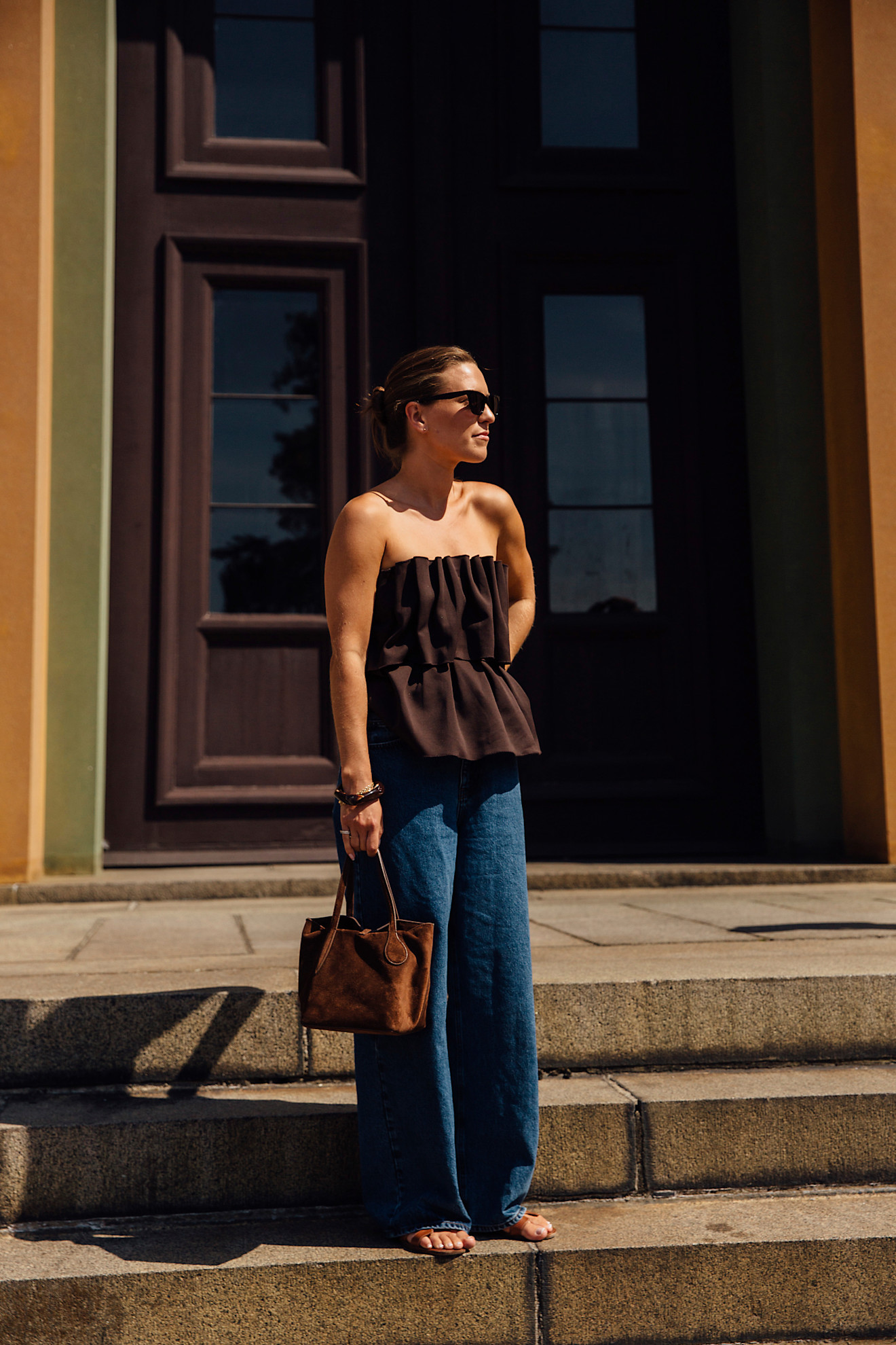 woman wearing a brown tube-top and jeans in Copenhagen.