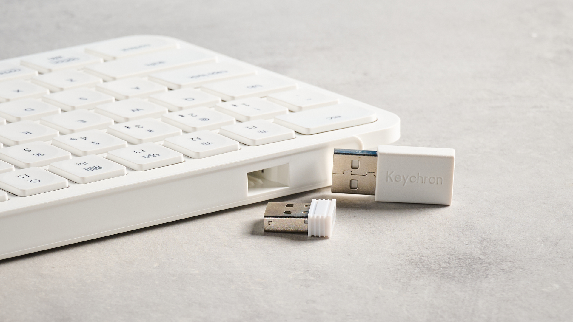 Keychron B2 Pro ultra-slim low profile keyboard in white photographed on a grey background.