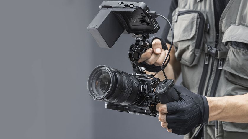 SmallRig cage kit for the Nikon ZR, attached to camera and held by videographer