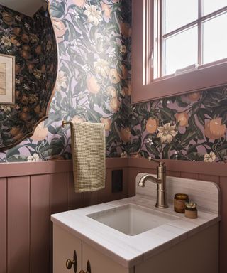 powder room with floral wallpaper and pink paneling