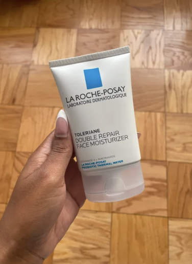 a person holding the la roche-posay skincare moisturizer