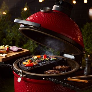 Kamado Joe Konnected Joe Digital Charcoal Grill and Smoker in Black and Red cooking barbecue food