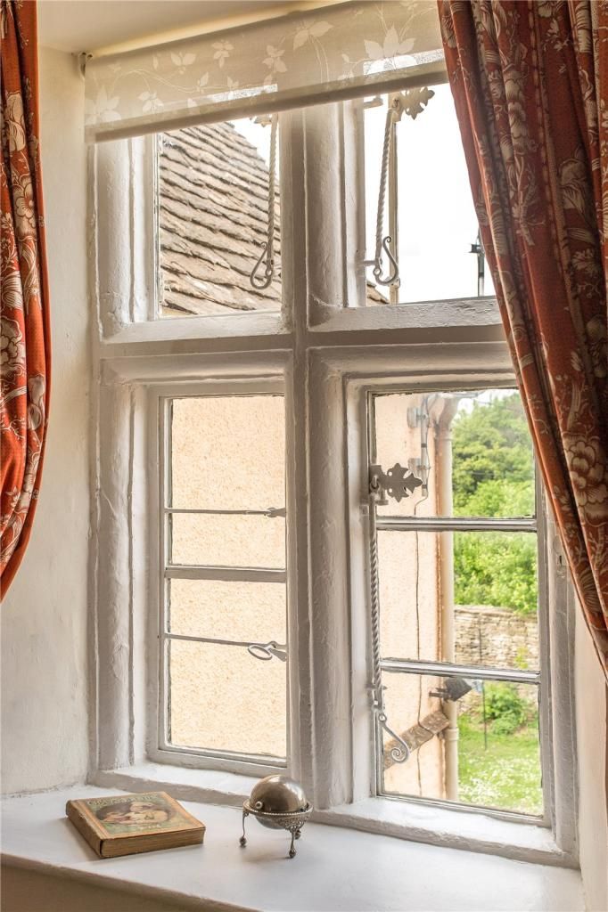 A large sash window looking out across the garden