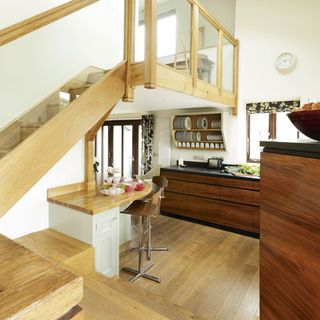kitchen with wooden stairs and dining