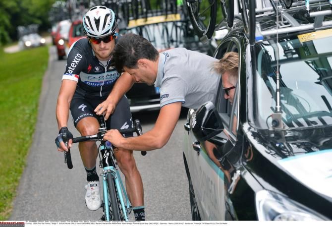 The Omega Pharma-Quick Step mechanic checks the camera on Michał Gołaś' bike