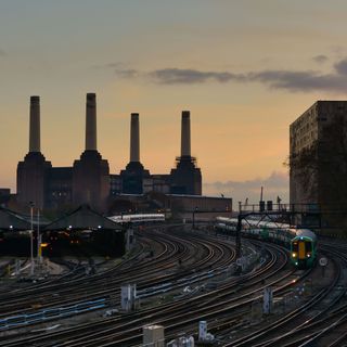 battersea power station at night and passing train