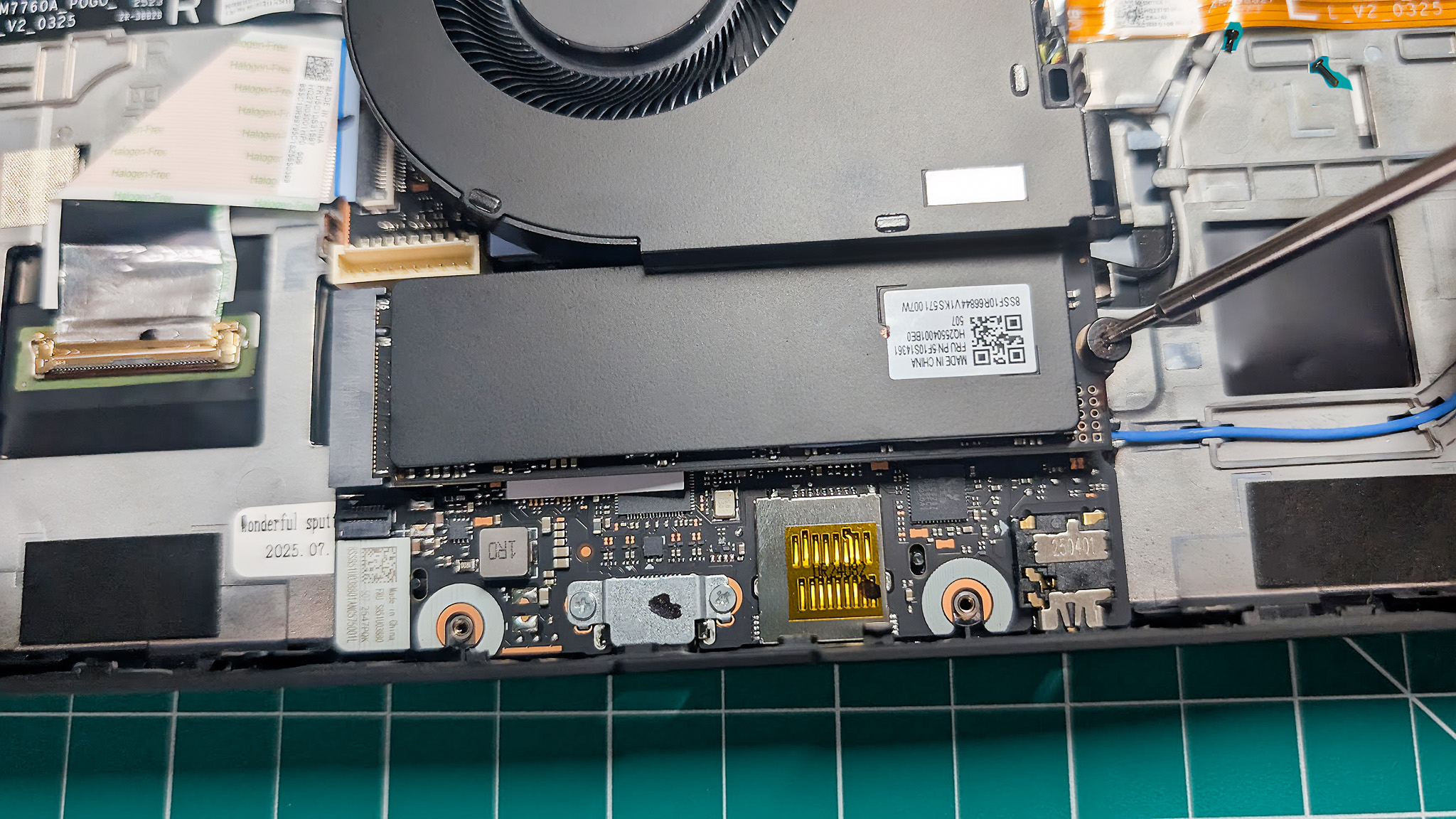 A closeup of the Lenovo Legion Go 2's SSD with a metal plate extending over it from the fan.  