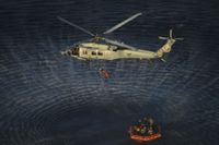 NASA Artemis II crew members are hoisted into a U.S. Navy MH-60 helicopter after successfully splashing down in the Pacific Ocean following their 10-day mission around the Moon.
