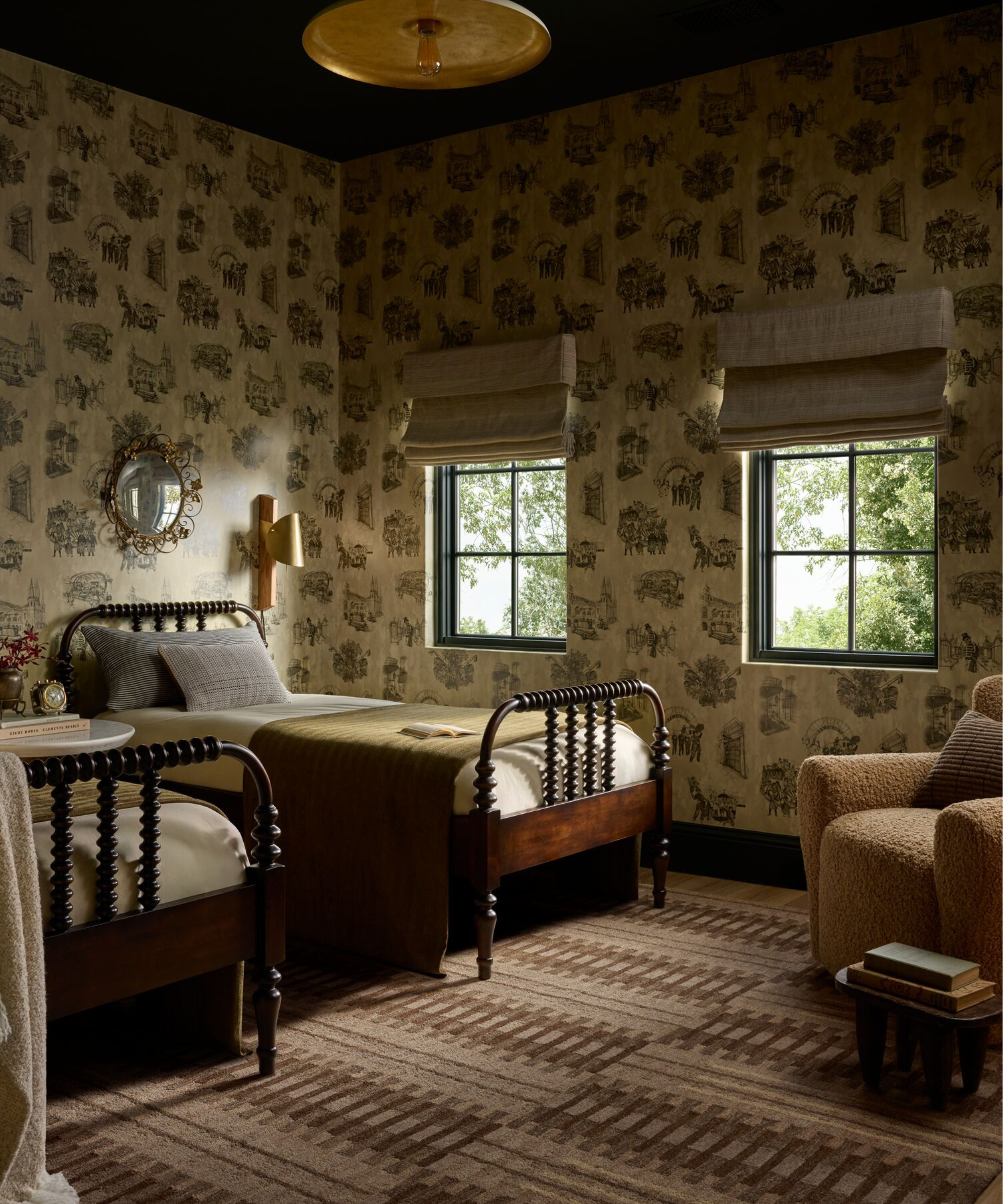 a bedroom with wallpaper, a brown patterned rug, and two twin beds