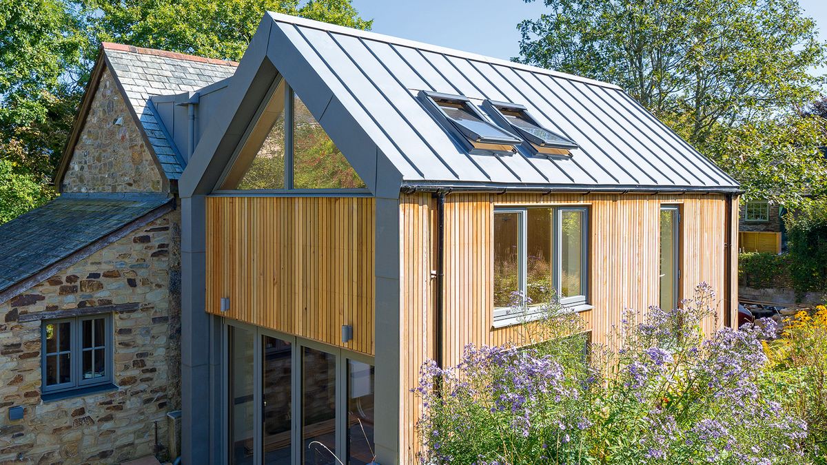 contemporary house with grey aluminium windows and vertical timber cladding