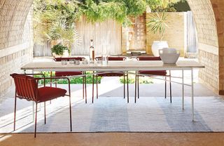 A large outdoor dining table with contemporary patio dining chairs
